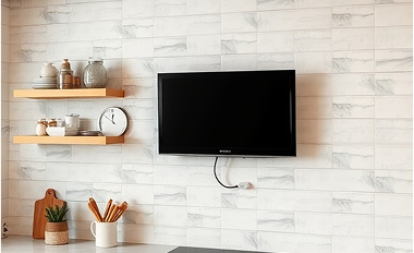 32" TV mounted on tile wall with swivel mount
